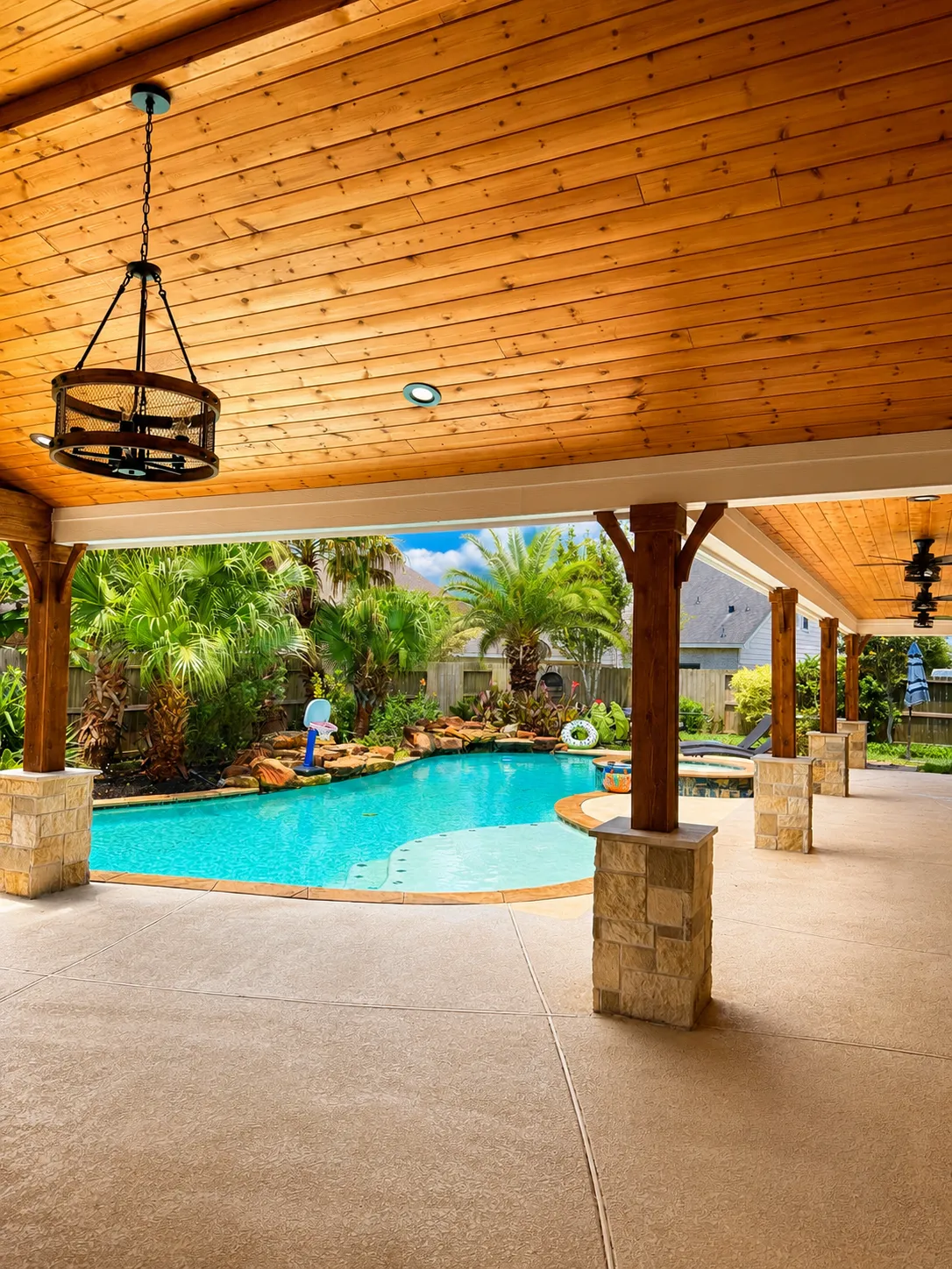 Covered patio pool rock waterfall chandelier